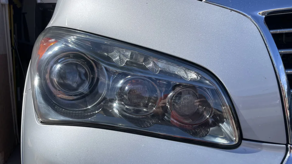 After view of the same headlight lens appearing clearer with internal lamp elements more visible.