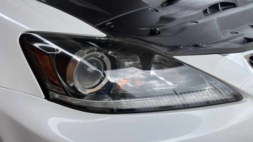 After view of the same headlight lens appearing clearer with internal lamp elements more visible.